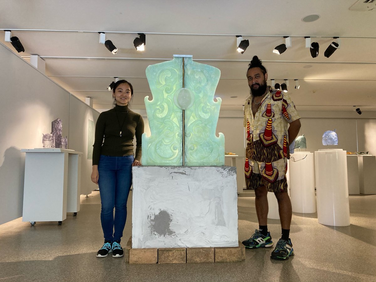 Photo of Nancy Yu and Ramesh Mario Nithiyendran standing on either side of Nancy's sculpture in her solo exhibition Glass Armours
