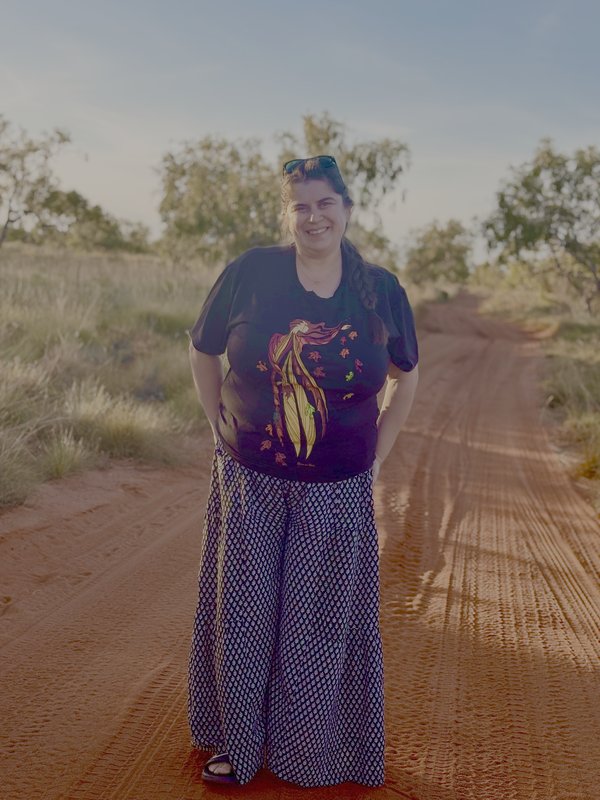 Photo of Jodie standing in a desert landscape.