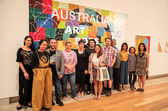 Blak curatorial exchange group in front of Richard Bell's "Bell's Theorem"