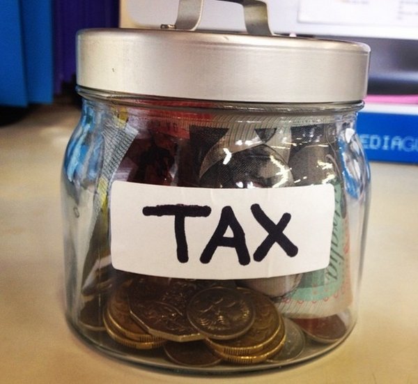 Jar labelled tax filled with money